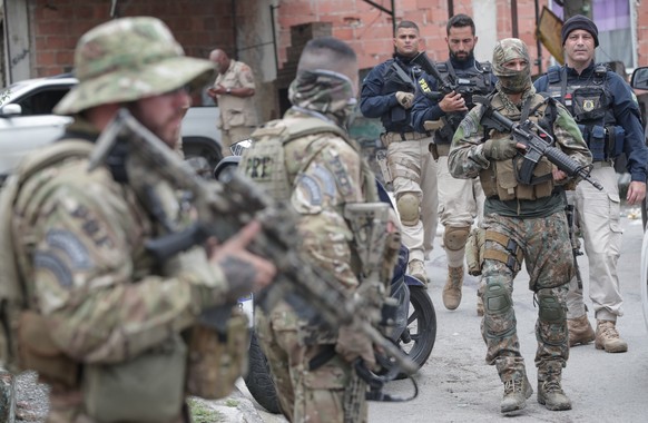 epa09747631 Members of the Militarized Police of Rio de Janeiro carry out an operation against drug trafficking in the favela of Vila Cruzeiro, in Rio de Janeiro, Brazil, 11 February 2022. At least ei ...