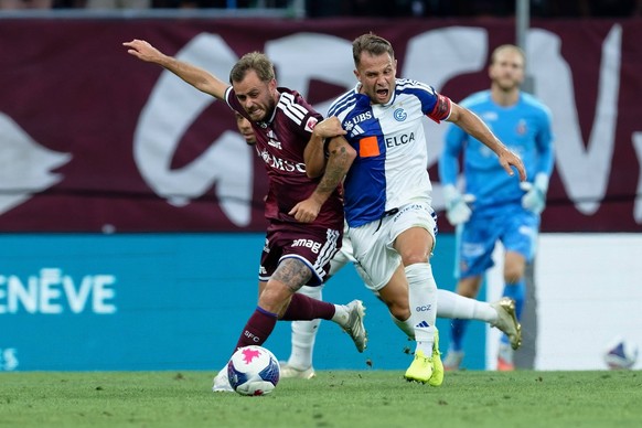 Geneva, Switzerland - August 08 : Timothe Cognat of Servette FC Amir Abrashi of Grasshopper Club Zurich battle for the ball duel during the Brack Super League match between Servette FC and Grasshopper ...