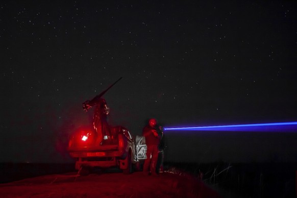 Ukrainian servicemen of the 126th brigade air-defense unit look for Russian drones during air alert in Kherson region, Ukraine, Oct. 3, 2024. (AP Photo/Marko Ivkov)
