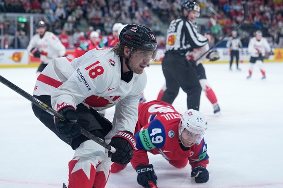 Canada's Robert Thomas (18) challenges for the puck with Norway's Christian Kaasastul (49) during the 2026 IIHF Men's Ice Hockey World Championship bronze medal match between Canada and ...