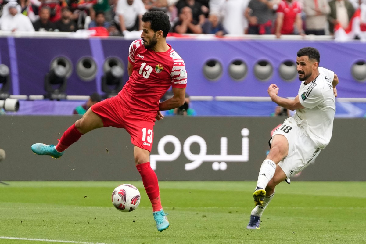 FILE - Iraq's Aymen Hussein, right, scores his side's second goal during the Asian Cup Round of 16 soccer match between Iraq and Jordan, at Khalifa International Stadium in Doha, Qatar, Mond ...