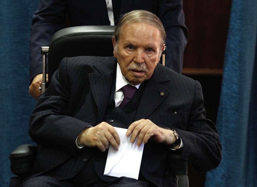 FILE - In this May 4, 2017 file photo, Algerian President Abdelaziz Bouteflika prepares to vote in Algiers. Embattled Algerian President Abdelaziz Bouteflika says he will step down before his fourth t ...