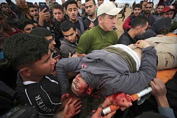 epa06637241 Palestinians carry the body of youth who was shot dead by Israeli troops during clashes after protests along the border between Israel and Gaza Strip, in the eastern Beit Hanun town, in th ...