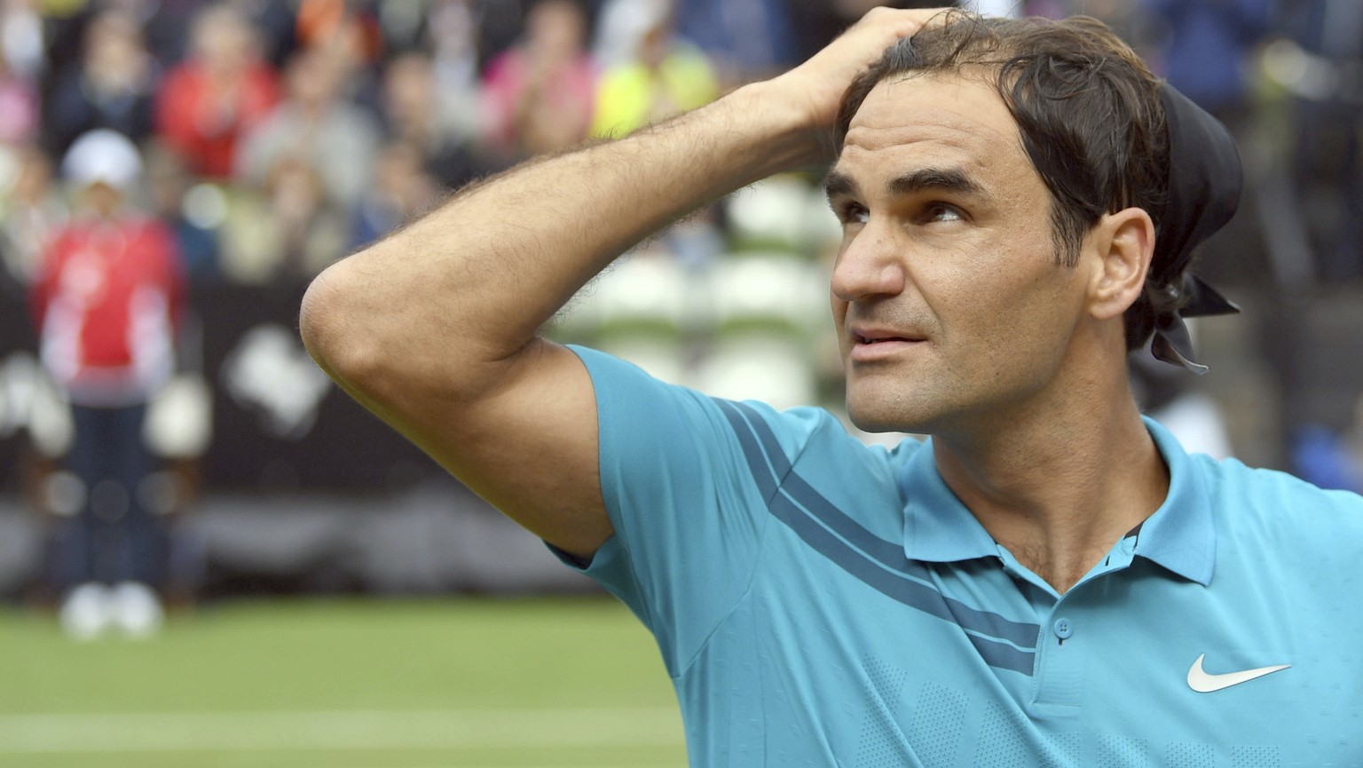 Roger Federer reacts as he defeats Mischa Zverev during the ATP Mercedes Cup tournament in Stuttgart, Germany, Wednesday, June 13, 2018. (Marijan Murat/dpa via AP)