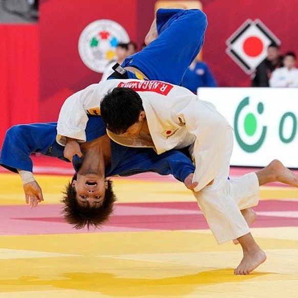 TOKYO, JAPAN - DECEMBER 07: Ryuju Nagayama of Japan (white) competes against Ruslan Poltoratskii of Bahrain (blue) in the Men's -60kg second round during day two of the Judo Grand Slam Tokyo at T ...