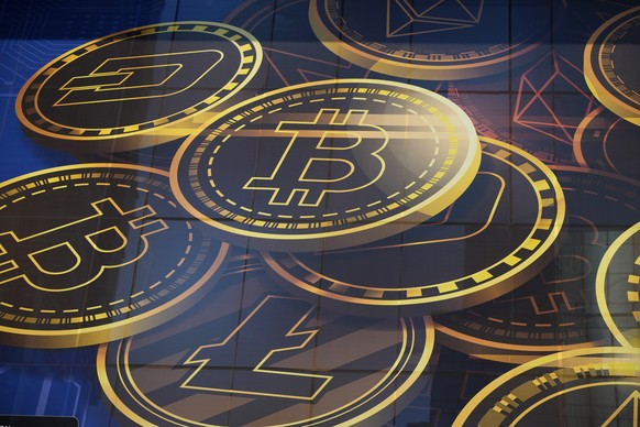 FILE - An advertisement of Bitcoin, one of the cryptocurrencies, is displayed on a building in Hong Kong, on Nov. 18, 2021. (AP Photo/Kin Cheung, File)