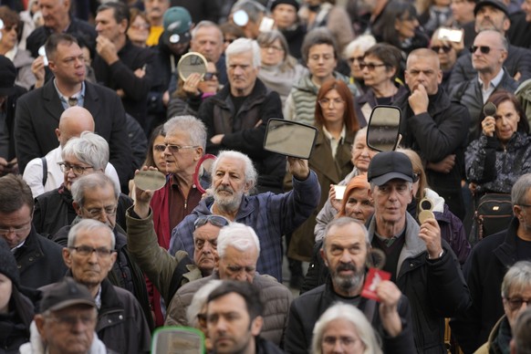 Media rights groups and opposition activists hold mirrors during a protest in front of the Serbian Court of Appeal, in Belgrade, Serbia, Monday, February 5, 2024. Media rights groups and opposition activists…