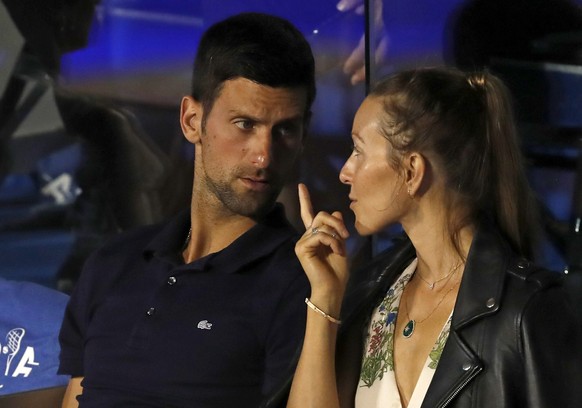 FILE - In this Sunday, June 14, 2020 file photo Serbia&#039;s Novak Djokovic, left, speaks with his wife Jelena during a final match of the Adria Tour charity tournament, between Austria&#039;s Domini ...