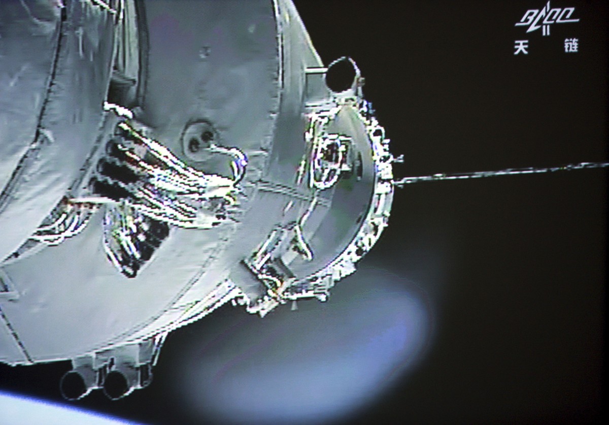 FILE - In this June 13, 2013, file image released by China's Xinhua News Agency, the Shenzhou-10 manned spacecraft is seen while conducting docking with the orbiting Tiangong-1 space module. Chin ...