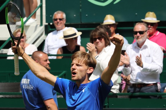 epa07665825 David Goffin from Belgium celebrates winning against against Matteo Berrettini from Italy during their semi final match at the ATP Tennis Tournament Noventi Open (former Gerry Weber Open) ...