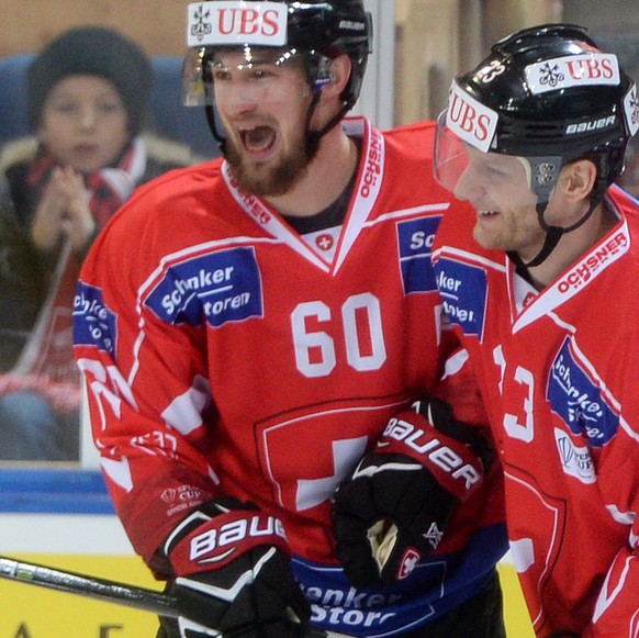 Team Suisse player Tristan Scherwey and Simon Bodenmann celebrates after scoring 1:0 during the game between Team Suisse and Haemeenlinna PK at the 91th Spengler Cup ice hockey tournament in Davos, Sw ...