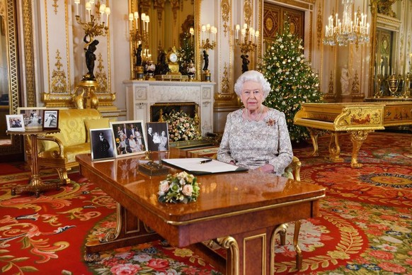 LONDON, UNITED KINGDOM - DECEMBER 25: Queen Elizabeth II poses for a photo after she recorded her annual Christmas Day message, in the White Drawing Room at Buckingham Palace in a picture released on  ...