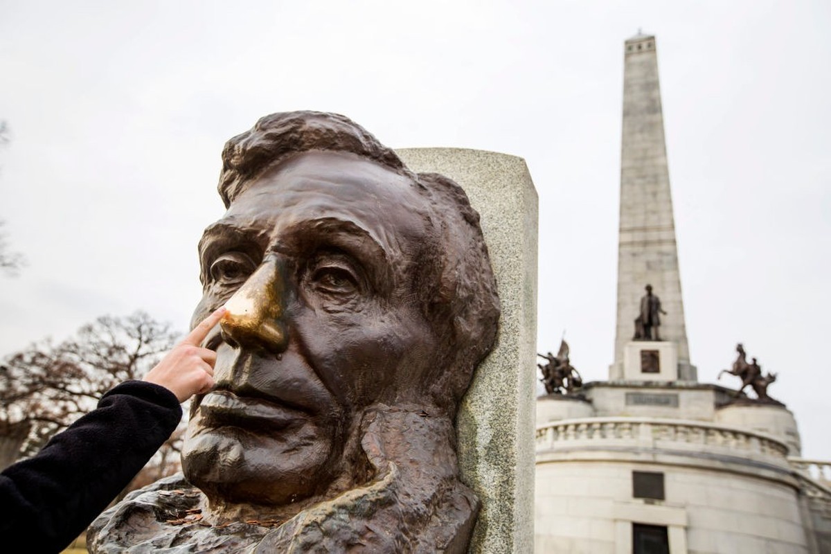 SPRINGFIELD, IL - MARCH 2 The remains of Abraham Lincoln, his wife, Mary, and three of their four sons rest within a stately tomb at Oak Ridge Cemetery in Springfield, Il. A visitor rubs Lincoln' ...