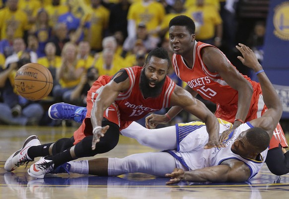 Houston Rockets guard James Harden (13) and center Clint Capela (15) try to get to a loose ball over Golden State Warriors center Festus Ezeli during the first half of Game 5 of the NBA basketball Wes ...