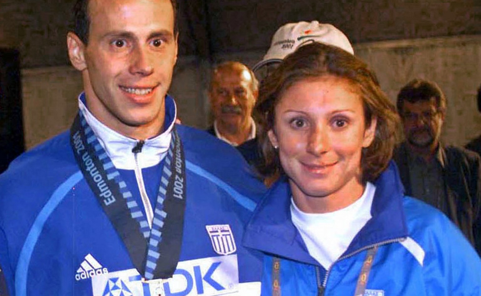 This is an August 9, 2001 photo of Greek athletes Konstantinos Kenteris, center, and Katerina Thanou, the 100-meter silver medalist in Sydney, right with their coach Christos Tsekos taken at the World ...