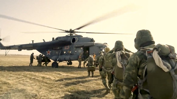 This handout photo taken from a video released on Friday, April 16, 2021 by Russian Defense Ministry Press Service shows, Russian special forces units board a helicopter during an exercise in the Tamb ...