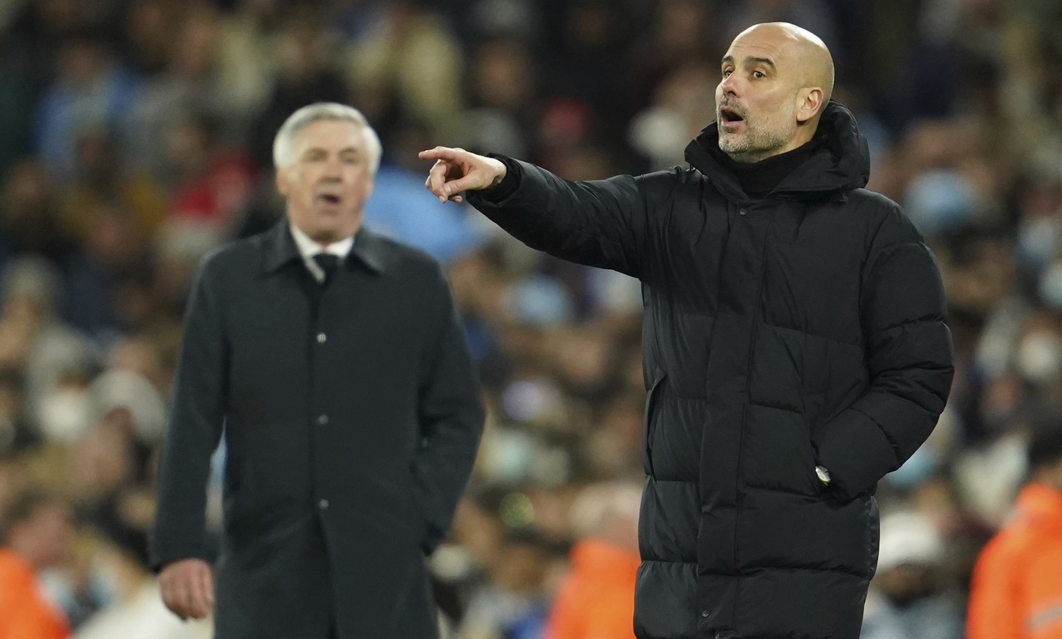 Real Madrid&#039;s head coach Carlo Ancelotti gestures as Manchester City&#039;s head coach Pep Guardiola, right, gives instructions from the side line during the Champions League semi final, first le ...