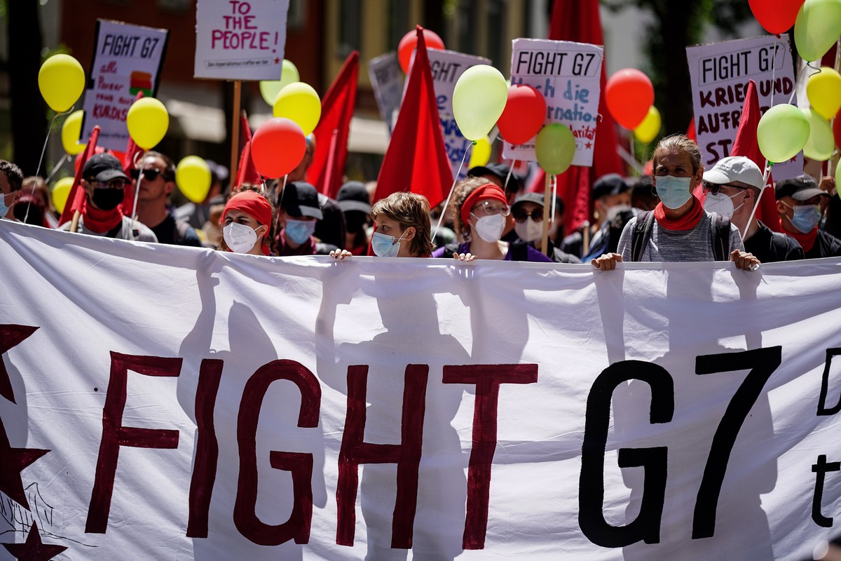 epa10033324 Protesters hold a banner during a demonstration related to the G7 Summit in Munich, Germany, 25 June 2022. Germany is hosting the G7 summit at Elmau Castle near Garmisch-Partenkirchen from ...