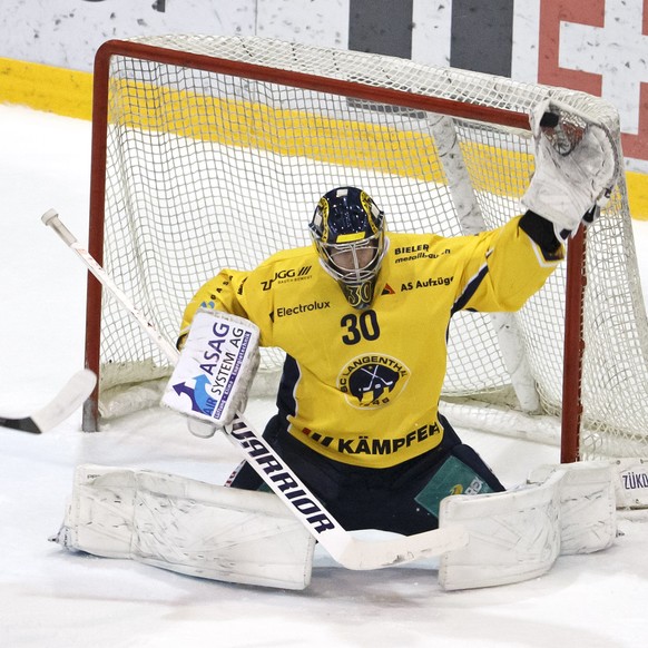 Langenthal&#039;s goaltender Philip Wuethrich, right, blocks the puck past Langenthal&#039;s defender Philippe Rytz, left, and La Chaux-de-Fonds&#039; center Alain Mieville, 2nd left, during the third ...