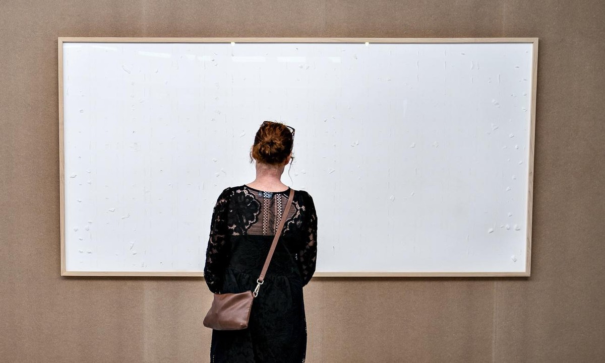 epa09492885 An empty picture frame, an artwork titled 'Take the Money and Run' by Danish artist Jens Haaning, in on display at the museum Kunsten in Aalborg, Sweden, 28 September 2021. The f ...