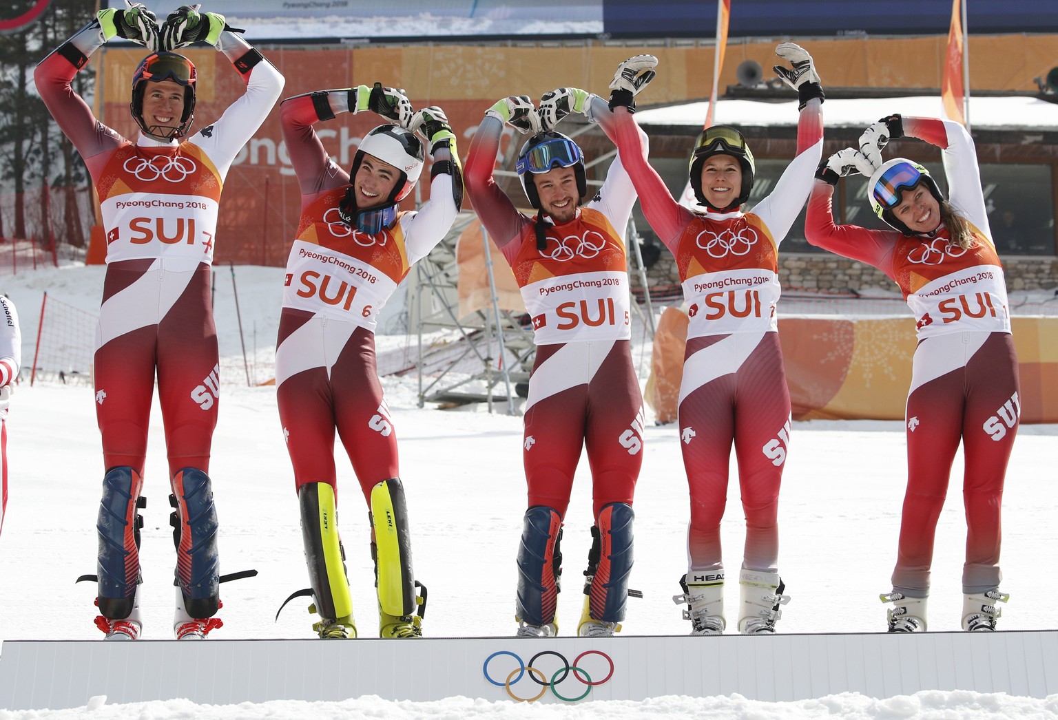 The Switzerland team, from left: Ramon Zenhaeusern, Denise Feierabend, Wendy Holdener, Daniel Yule and Luca Aerni, pose for photos after winning gold in the alpine team event at the 2018 Winter Olympi ...