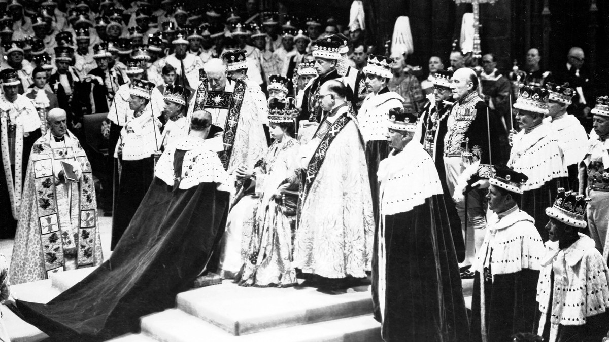 FILE - Britain's Prince Philip, the Duke of Edinburgh, kneeling, places his hands between those of Queen Elizabeth II, his wife, as he swears homage, during the Queen's Coronation ceremony a ...