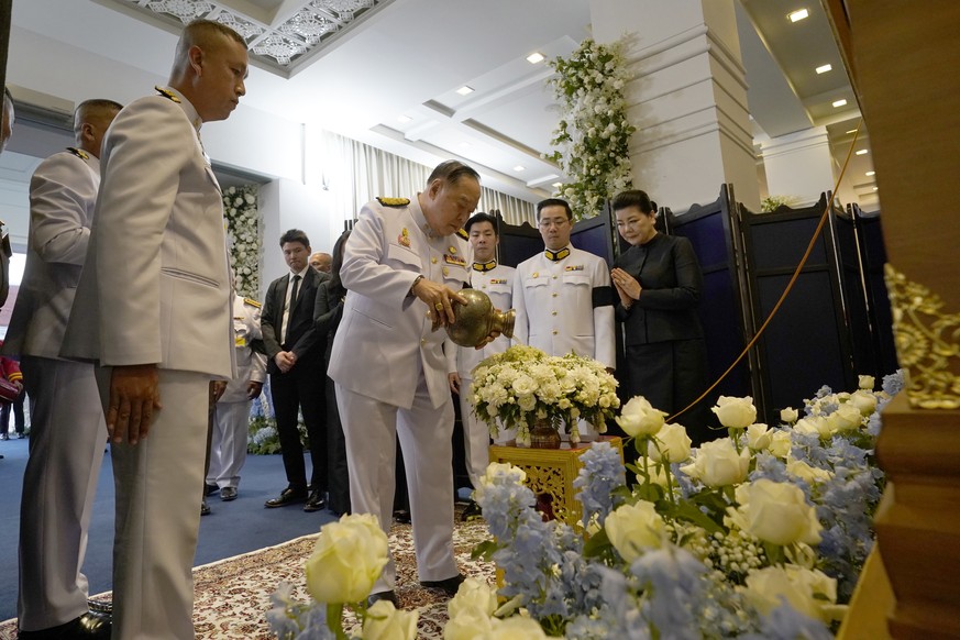 In this photo issued by King Power, deputy prime minister of Thailand, Gen. Prawit Wongsuwan, center, participates in the Buddhist funeral rituals of Vichai Srivaddhanaprabha in Bangkok, Thailand, Sat ...