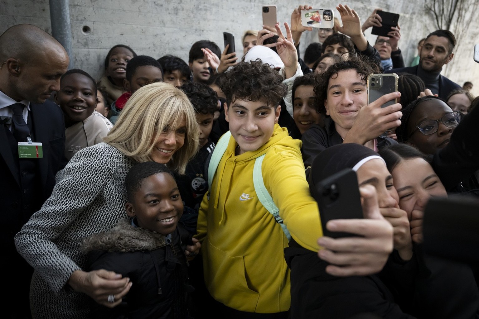 France&#039;s First Lady Brigitte Macron, takes a selfie with students, after a visit of a class of students at the public school of french language (Ecole cantonale de langue fran�aise), in Bern, Swi ...