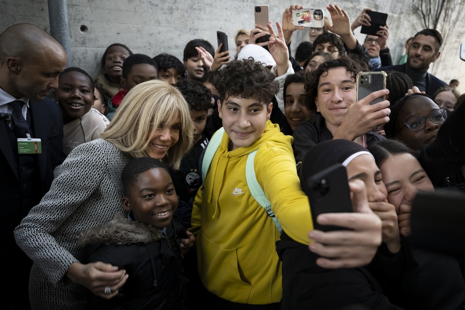 French First Lady Brigitte Macron takes a selfie with students, after a class of students visited the Public School for the French Language (Ecole cantonale de langue fran�aise), in Bern, Switzerland.