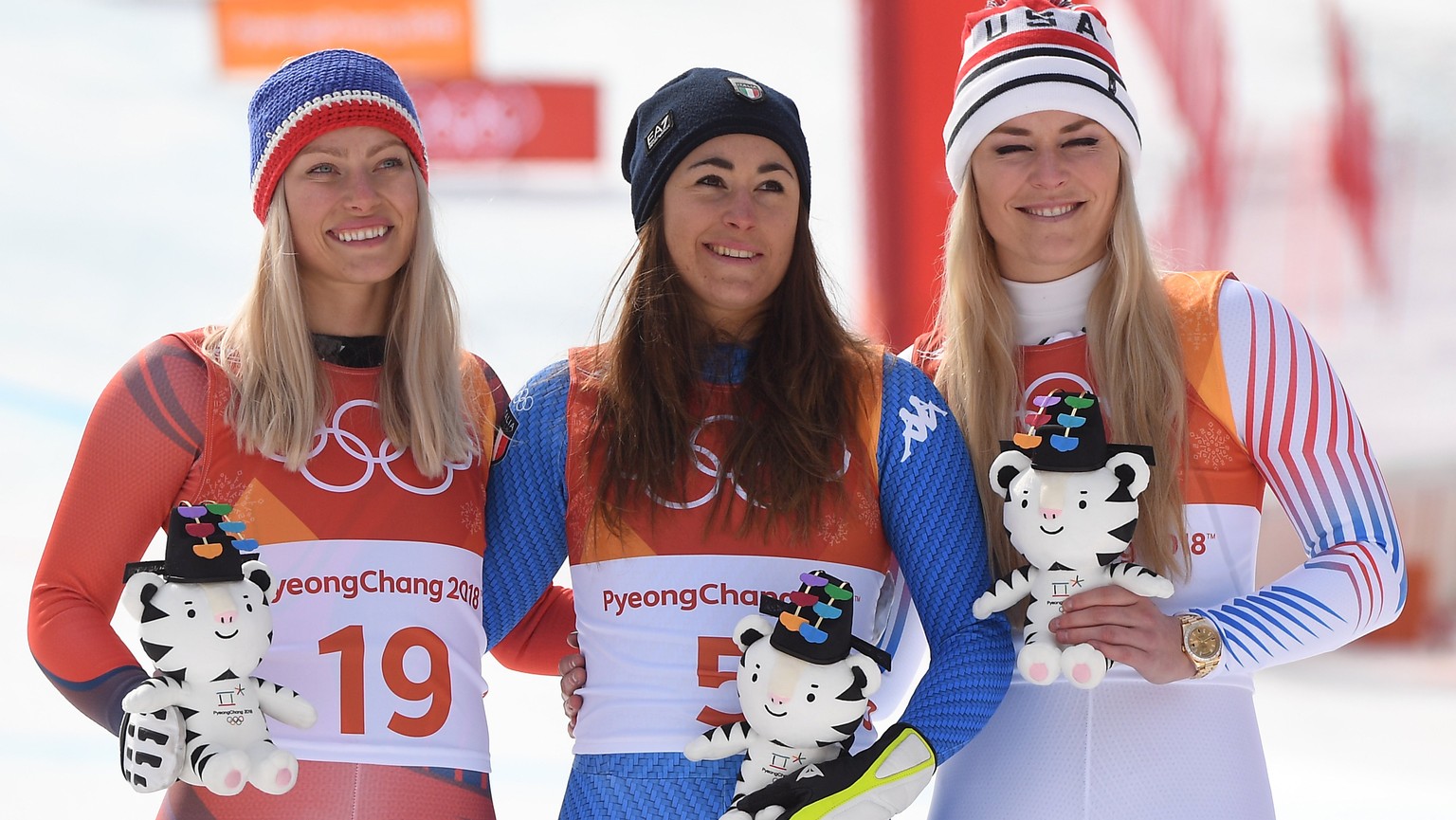 epa06548363 (L-R) Silver medal winner Ragnhild Mowinckel of Norway, gold medal winner Sofia Goggia of Italy and bronze medal winner Lindsey Vonn of the USA react during the venue ceremony of the Women ...