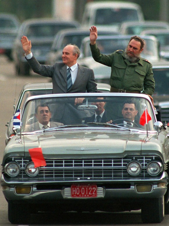 FILE - Cuban President Fidel Castro, right, and Soviet leader Mikhail Gorbachev wave to the crowd as their motorcade takes them through downtown Havana, Cuba, Monday, April 3, 1989. Russian news agenc ...