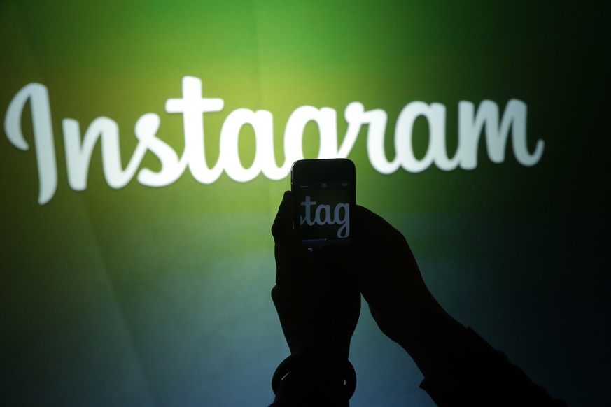 FILE - In this June 20, 2013 file photo, a journalist makes a video of the Instagram logo using the new video feature at Facebook headquarters in Menlo Park, Calif. The California Supreme Court will d ...