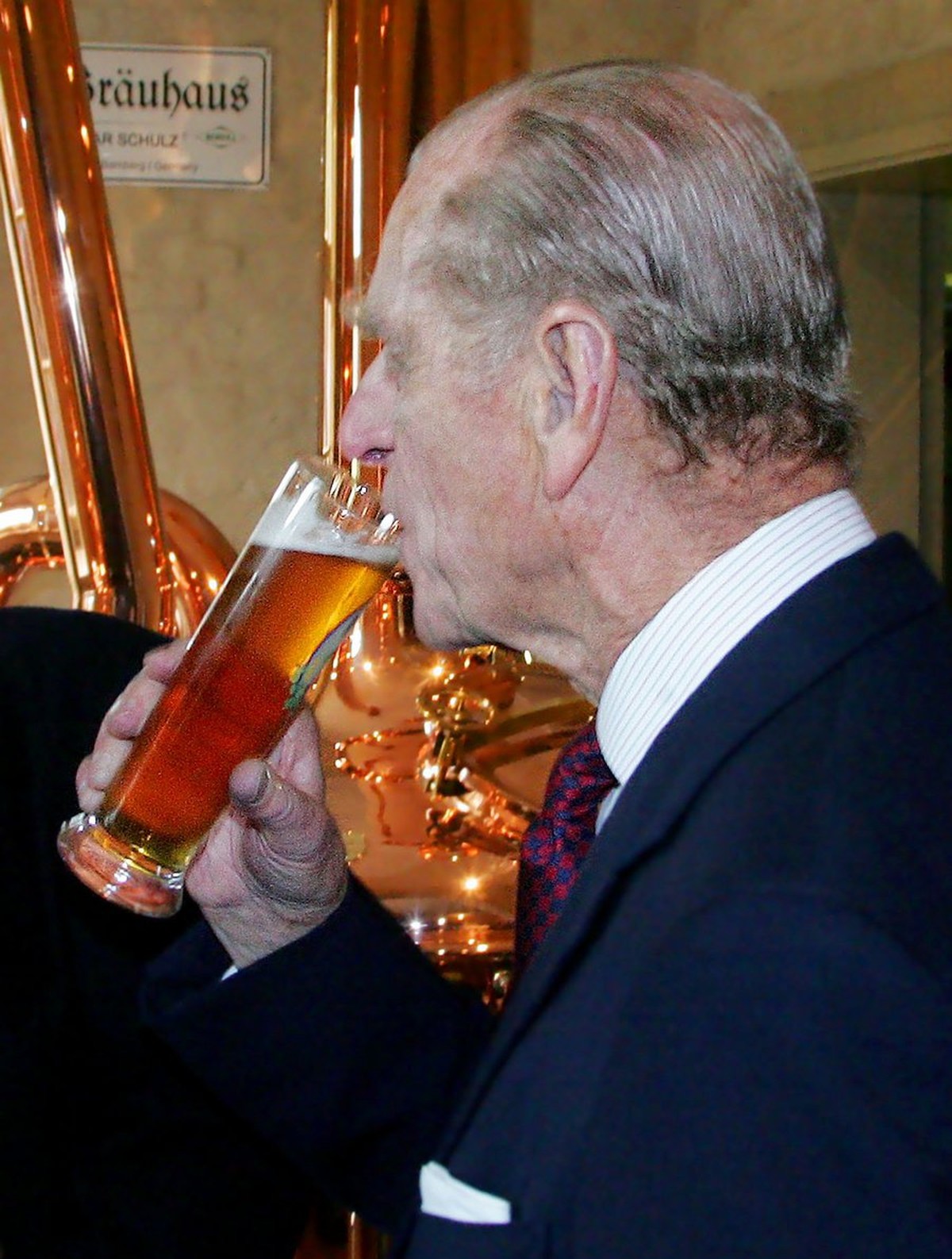 Britain's Prince Philip drinks beer in a brewery in Potsdam, near Berlin. Queen Elizabeth II and Prince Philip stay on a three-day visit in Germany. (AP Photo/Michael Hanschke, Pool)