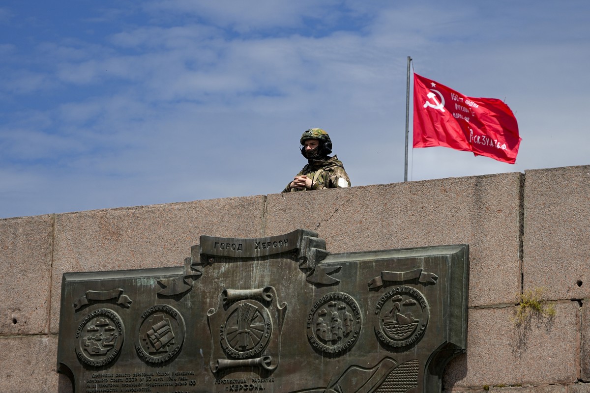 FILE - A Russian soldier guards an area by the Alley of Glory exploits of the heroes - natives of the Kherson region, who took part in the liberation of the region from the Nazi invaders, in Kherson,  ...