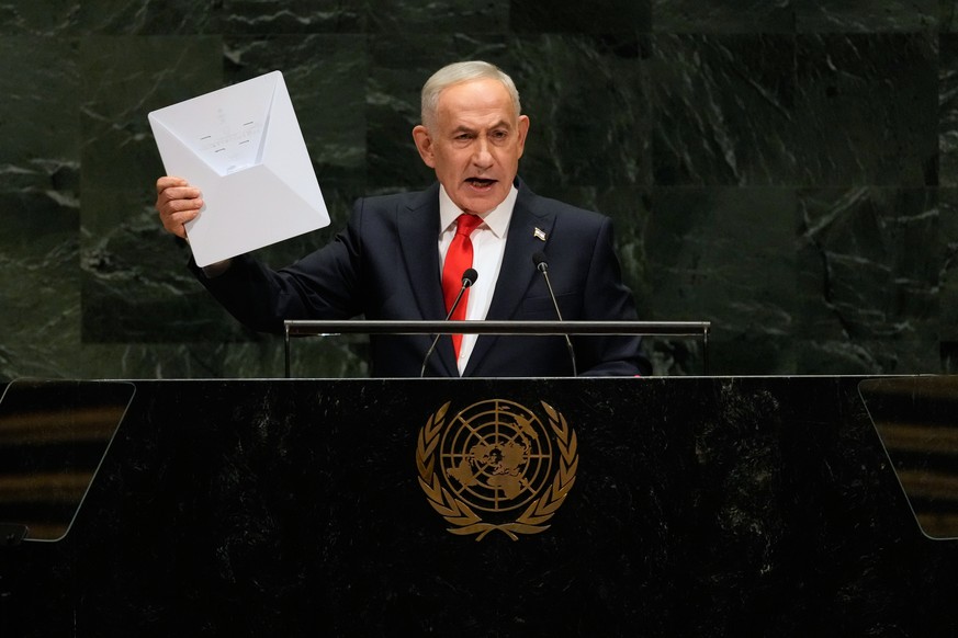 Israeli Prime Minister Benjamin Netanyahu holds up a Starlink satellite internet dish a he speaks during the 81st session of the United Nations General Assembly at United Nations headquarters, Thursda ...