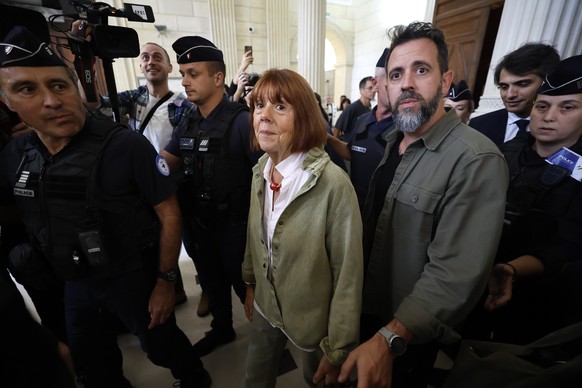 epa12436731 Gisele Pelicot (L) accompanied by her son Florian Pelicot (R), leaves the Gard criminal court, in Nimes, France, 07 October 2025. An appeal trial involving one of the defendants sentenced  ...