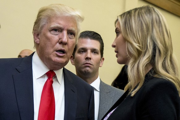 FILE - Donald Trump, left, his son Donald Trump Jr., center, and his daughter Ivanka Trump speak during the unveiling of the design for the Trump International Hotel, in Washington, Sept. 10, 2013. Fo ...