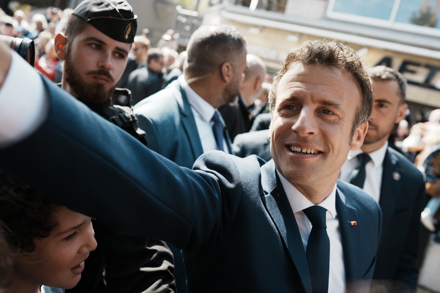 French President and centrist candidate Emmanuel Macron shakes hands with well-wishers as he heads to the polling station in Le Touquet, northern France, Sunday, April 24, 2022. France began voting in ...