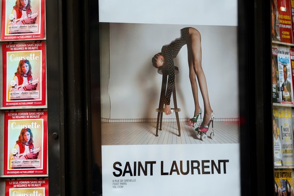 An ad by French fashion house Yves Saint Laurent is seen on a newspaper kiosk in Paris, France, March 6, 2017. France&#039;s advertising watchdog on Monday said it had asked French fashion house Yves  ...