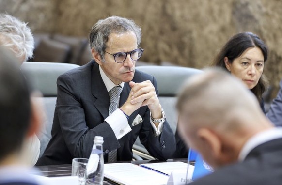 epa10708365 A handout photo made available by the ROSATOM Press Service shows IAEA Director General Rafael Grossi (C) attending a consultation meeting between the Russian delegation and the IAEA the…