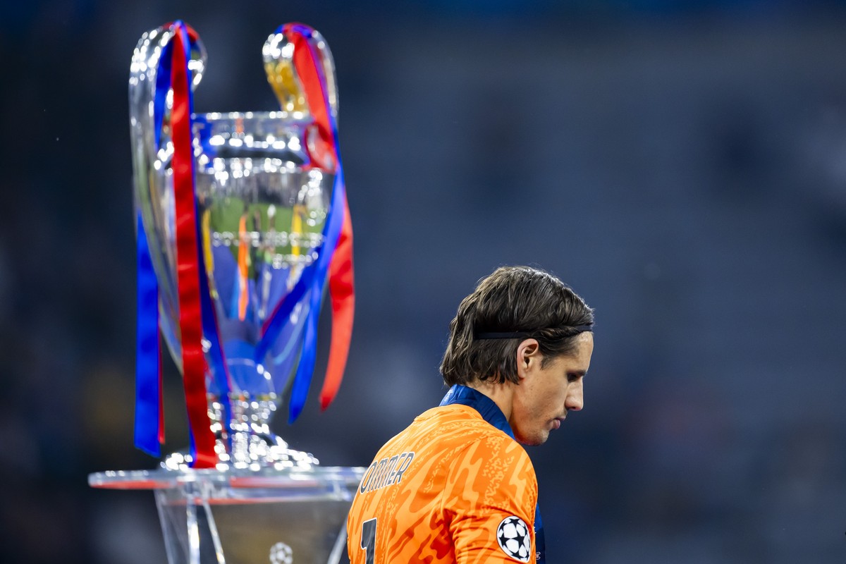 Inter Milan's goalkeeper Yann Sommer looks disappointed as he walks past the Champions League trophy after losing the Champions League final soccer match against Paris Saint-Germain at the Allian ...