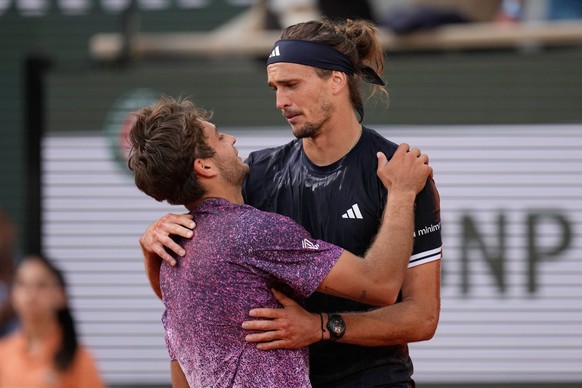 Second placed Flavio Cobolli of Italy, left, greets winner Alexander Zverev of Germany after their men's final match at the French Open tennis tournament in Paris, Sunday, June 7, 2026. (AP Photo ...