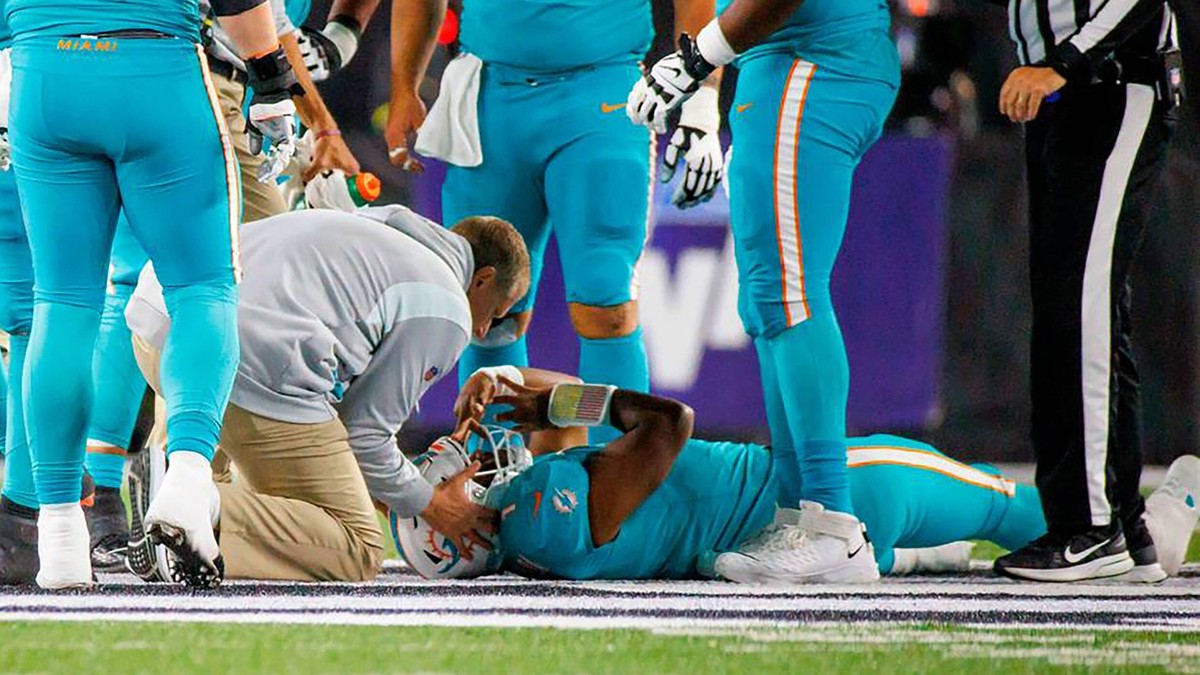 September 29, 2022, Miami, Florida, USA: Miami Dolphins quarterback TUA TAGOVAILOA 1 is attended by medical staff after being sacked by Cincinnati Bengals defensive tackle Josh Tupou during the second ...