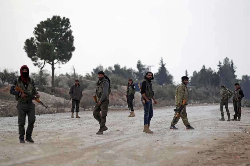 Free Syrian Army fighters carry their weapons as they stand on the outskirts of the northern Syrian town of al-Bab, Syria February 4, 2017. Picture taken February 4, 2017. To match Exclusive MIDEAST-C ...