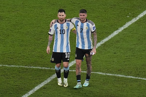 Argentina&#039;s Lionel Messi, left, and teammate Rodrigo De Paul walk along the pitch at the end of the World Cup round of 16 soccer match between Argentina and Australia at the Ahmad Bin Ali Stadium ...