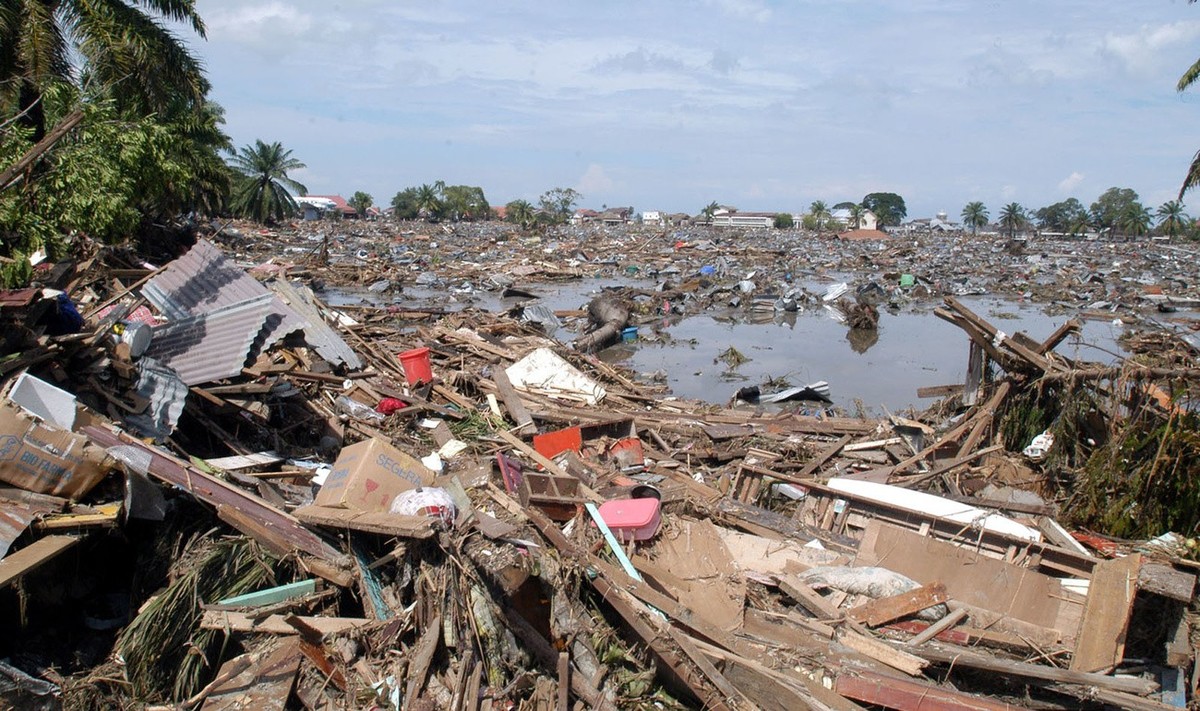Destroyed houses are seen in Banda Aceh, Indonesia Monday, Dec. 27, 2004. Dozens of bloated bodies littered the streets of Banda Aceh city Monday as soldiers and volunteers searched for survivors of a ...