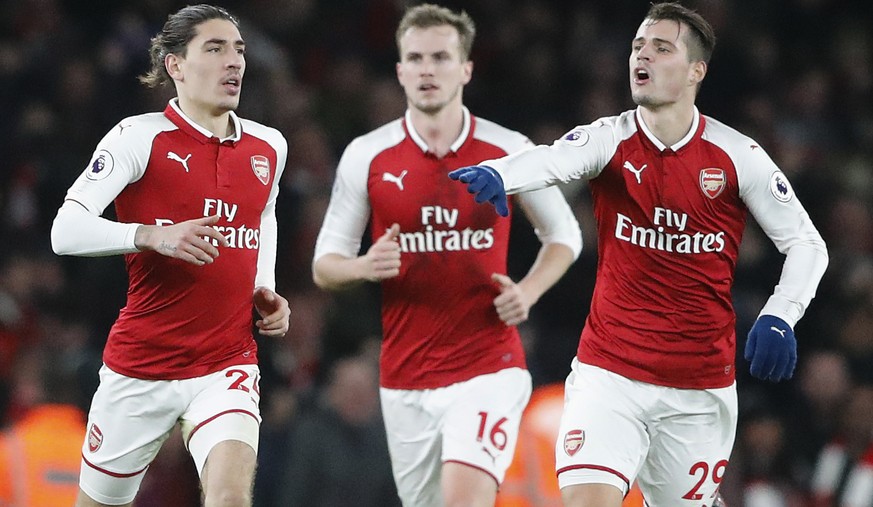 Arsenal&#039;s Hector Bellerin, left, celebrates scoring his side&#039;s second goal with Arsenal&#039;s Granit Xhaka during the English Premier League soccer match between Arsenal and Chelsea at Emir ...