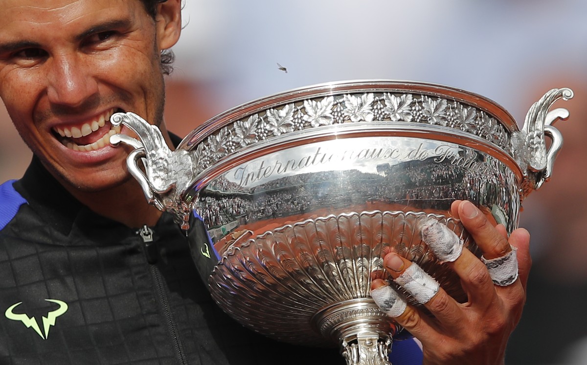 FILE - Spain's Rafael Nadal bites the trophy as he celebrates winning his tenth French Open title against Switzerland's Stan Wawrinka after their men's final match of the French Open te ...