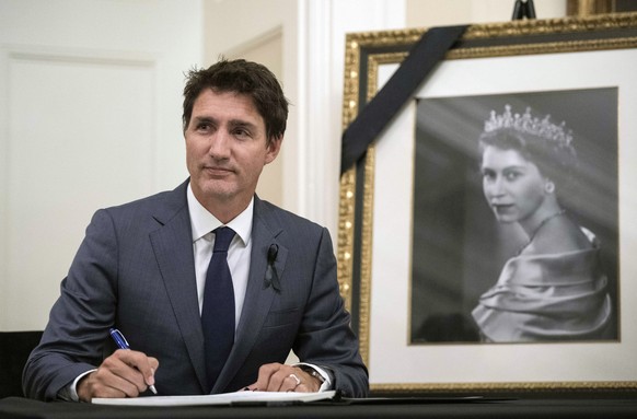 Prime Minister Justin Trudeau looks up after signing a book of condolences for Queen Elizabeth II, at Rideau Hall in Ottawa, Ontario on Friday, Sept. 9, 2022. (Justin Tang/The Canadian Press via AP)