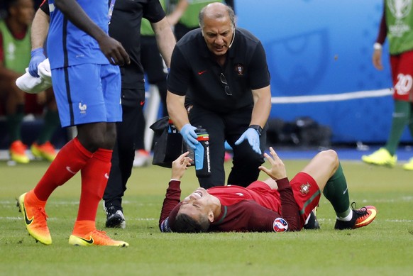 epa05419078 Cristiano Ronaldo of Portugal reacts on the pitch after a tackle during the UEFA EURO 2016 Final match between Portugal and France at Stade de France in Saint-Denis, France, 10 July 2016.  ...